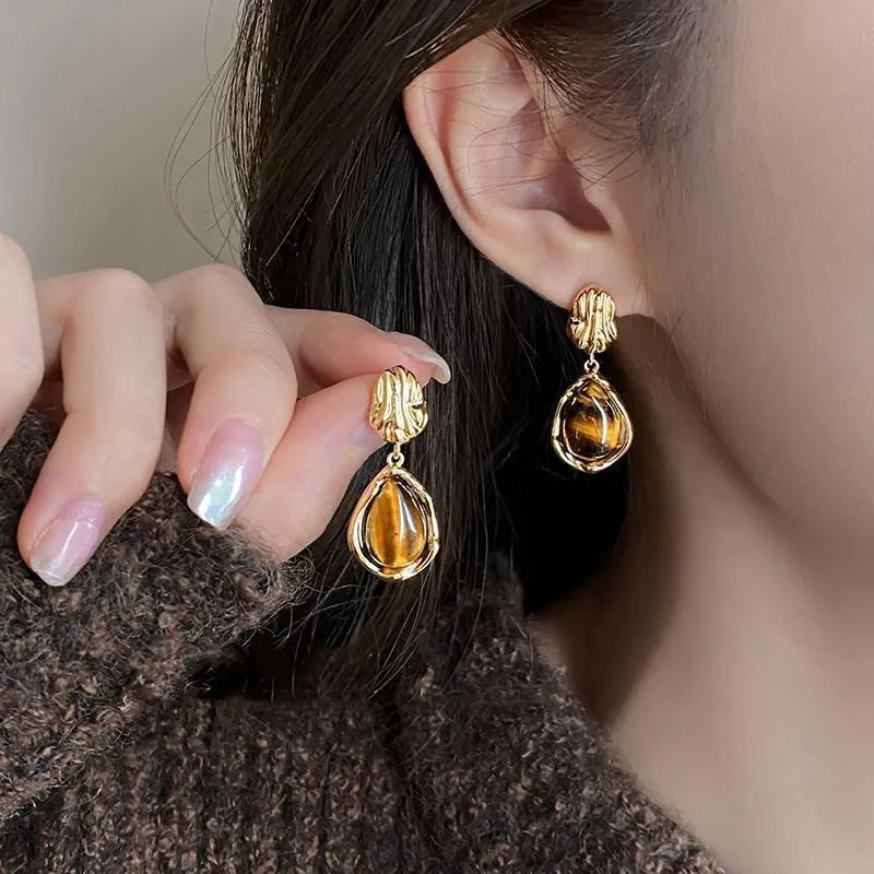Three pairs of handmade geometric ear studs with electroplated alloy construction and tassel detailing in different colour treatments