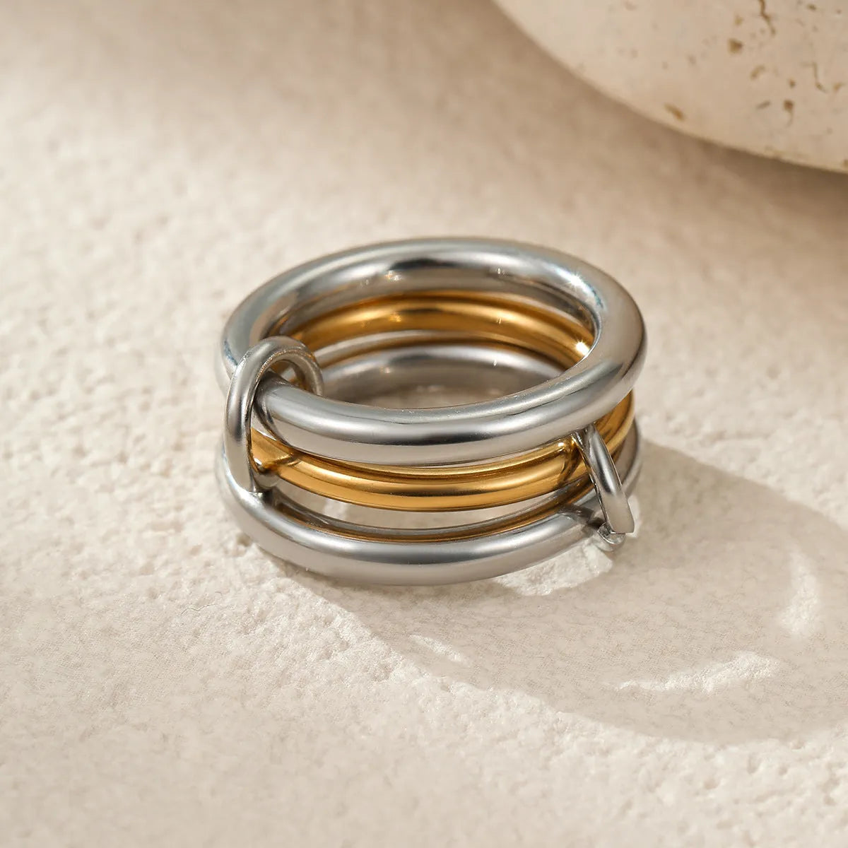 Gold plated exaggerated stackable ring for women on a hand, showing layered jewellery style.