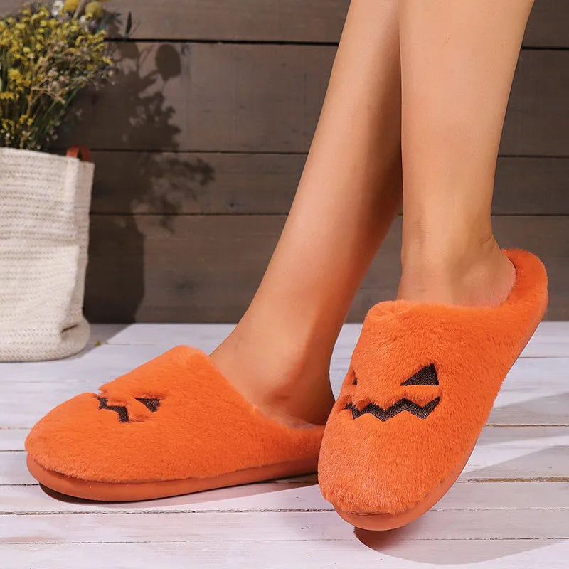Orange coral velvet Halloween pumpkin slippers with plush lining and a grey non-slip PVC sole.