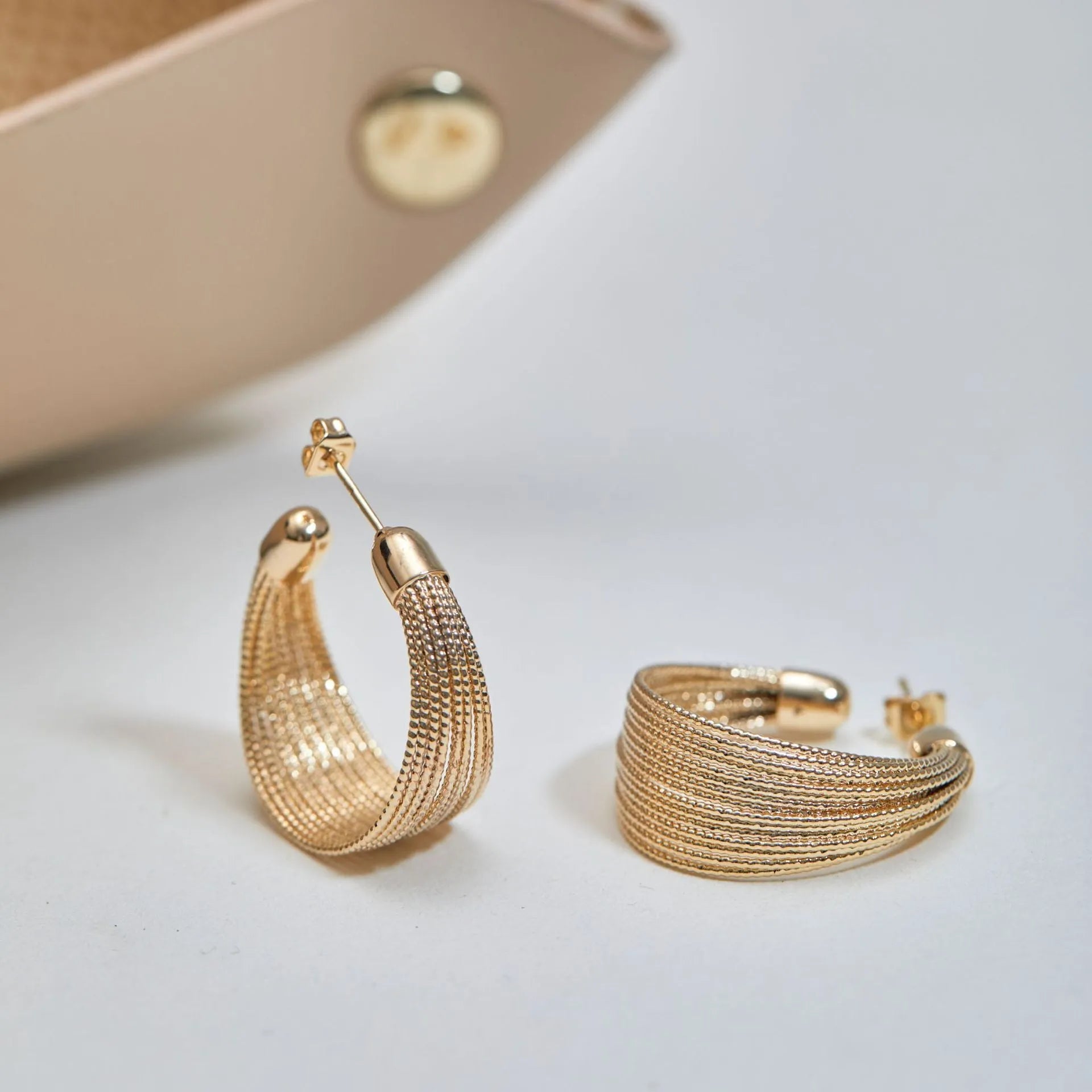 Geometric copper stud and clip earrings in gold and silver electroplated colours with simple multi-layer design