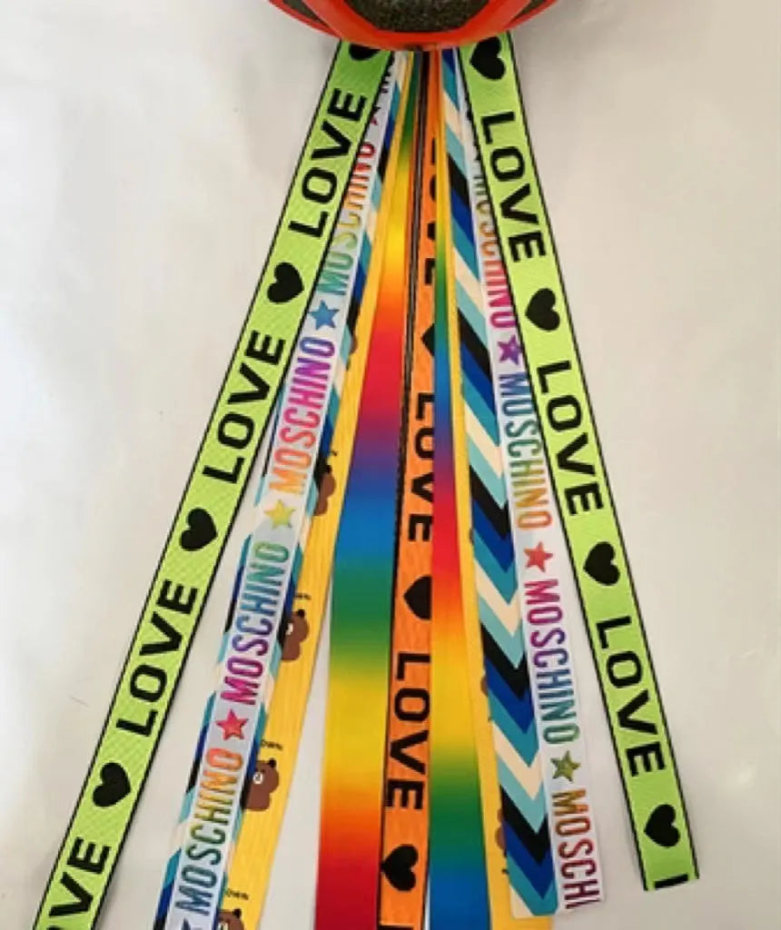 Colourful decorative ribbon streamers attached to a children safety helmet for skating or skiing