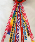 Colourful decorative ribbon streamers attached to a children safety helmet for skating or skiing