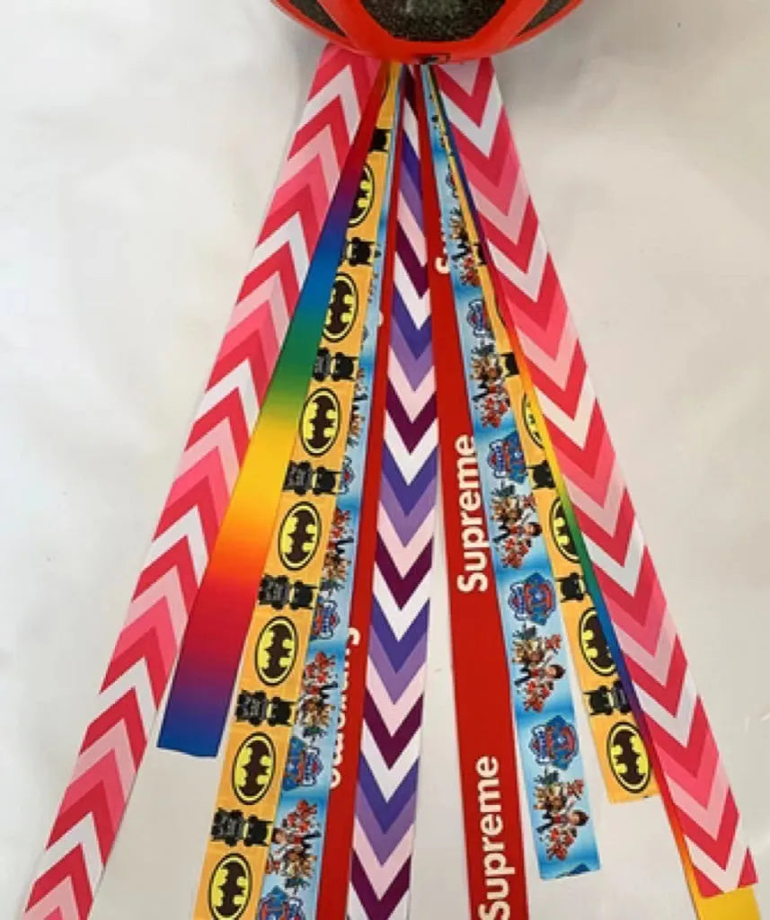 Colourful decorative ribbon streamers attached to a children safety helmet for skating or skiing