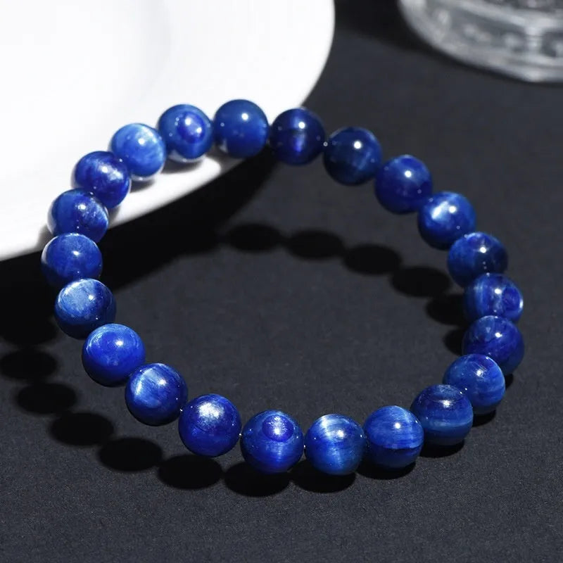 Natural blue crystal ball bracelet with geometric shape and Ruyi detail on a white background.