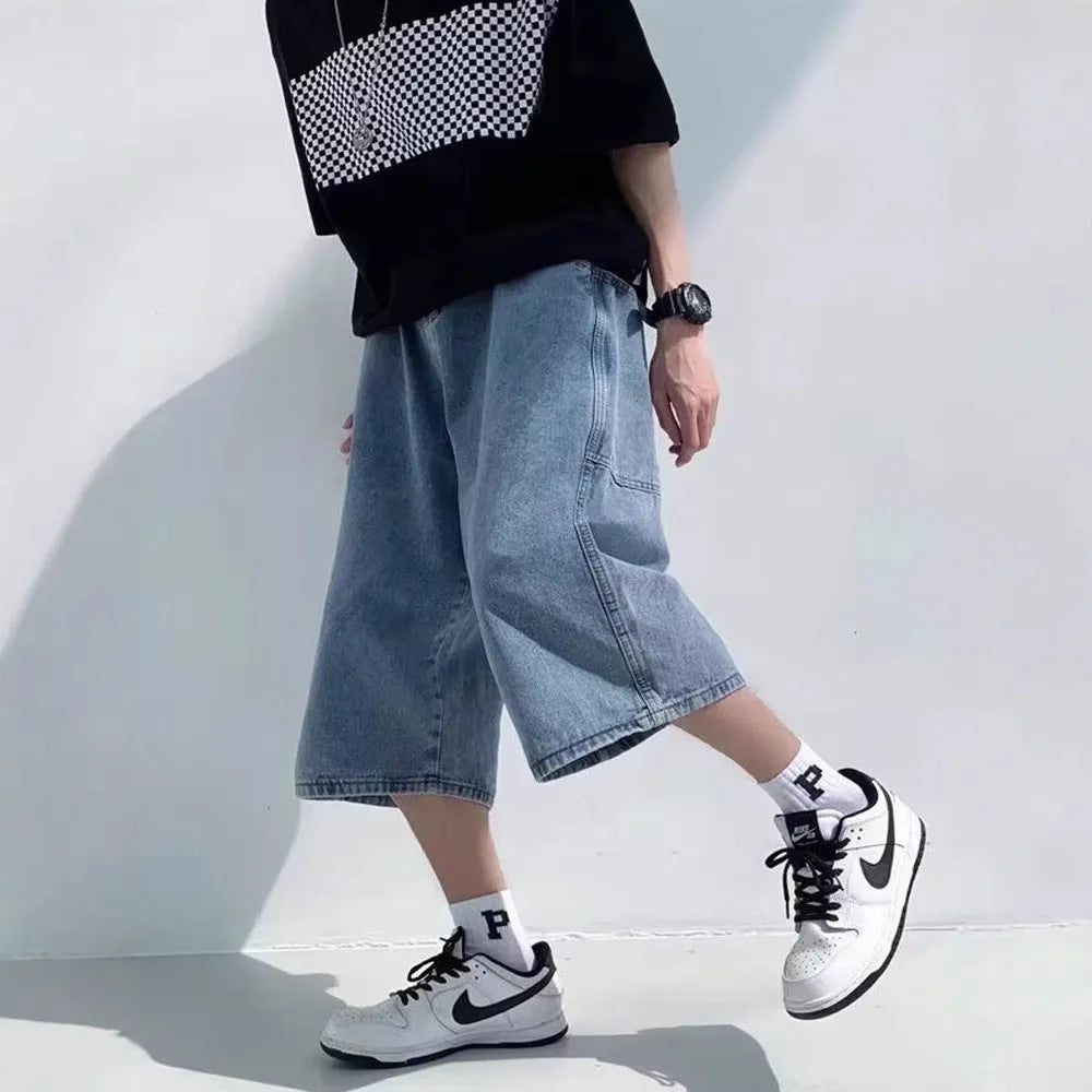 Men's washed blue denim pirate shorts with high waist and cropped straight legs on a plain background