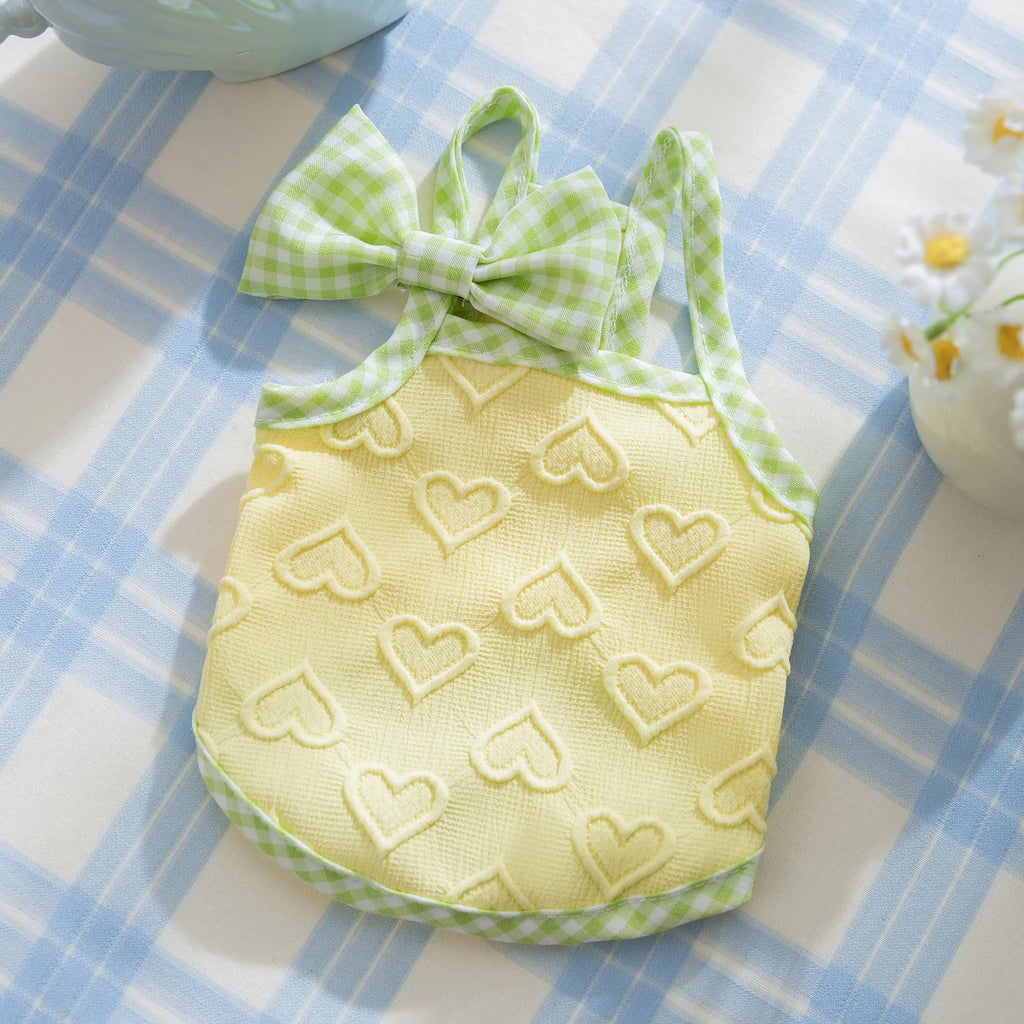 Small dog wearing heart texture vest with bow suspenders in Bondi Blue colour