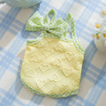 Small dog wearing heart texture vest with bow suspenders in Bondi Blue colour