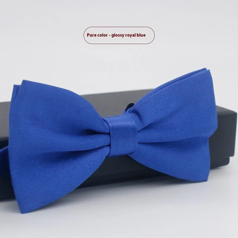 Men's flat head style polyester bow tie in a solid colour, shown with adjustable neck strap.