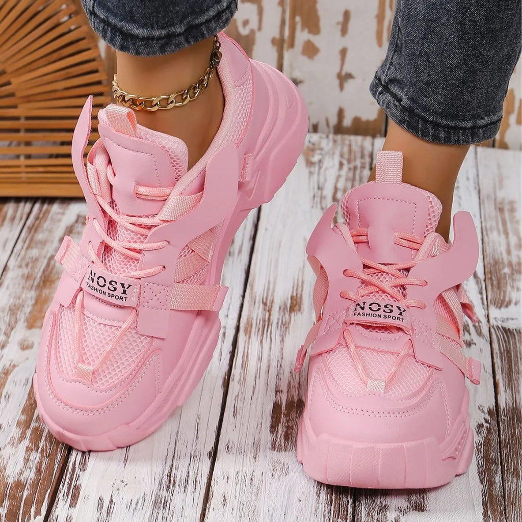 Women's purple platform sneaker with breathable mesh upper and lace-up front on a neutral background.
