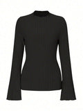 Man wearing black brushed polyester slim fit long sleeve top with sunken stripe design and round neck