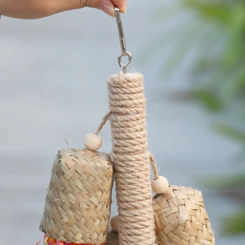 Wooden parrot toy with colourful shredded paper hanging by sisal rope