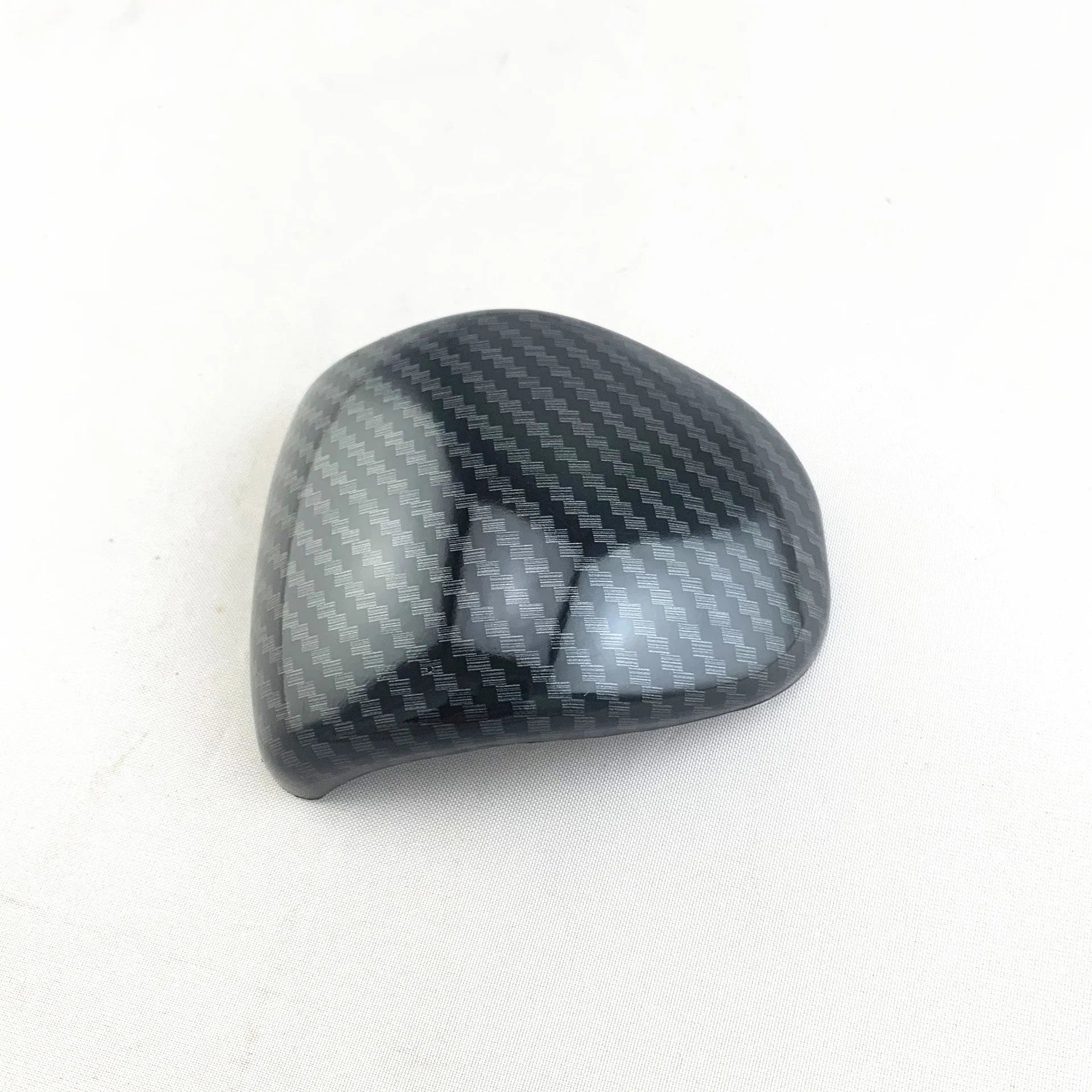 Black carbon fibre pattern gear shift cover for car interior with textured anti-slip surface