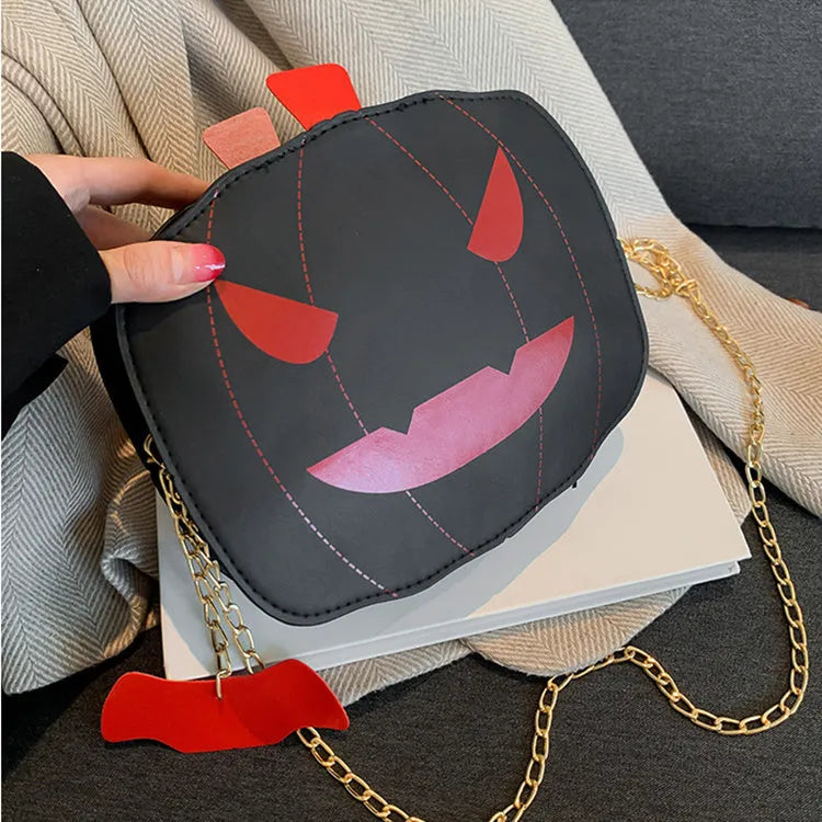 Cartoon pumpkin shoulder bag in orange with chain strap on white background