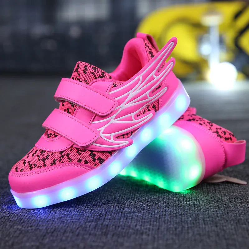 Plum red and white children's LED light-up sneakers showing USB charging port and hidden colour-selector switch.