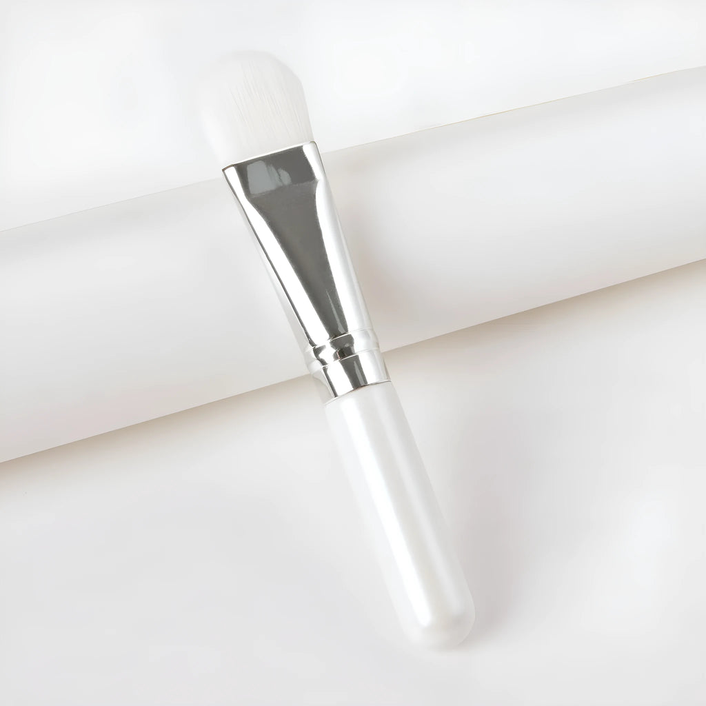 Wooden handle portable facial treatment brush with artificial fibre bristles on white background