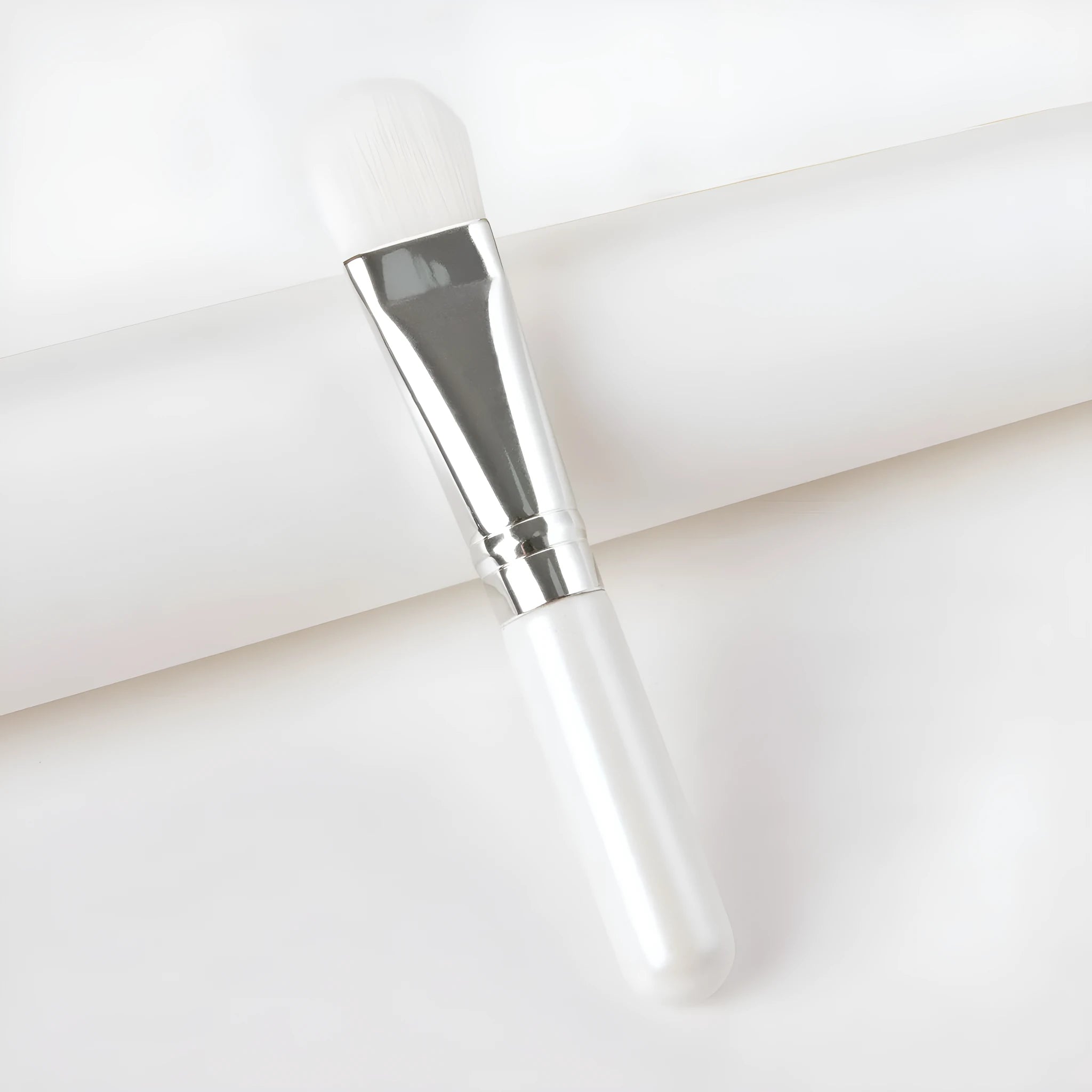 Wooden handle portable facial treatment brush with artificial fibre bristles on white background