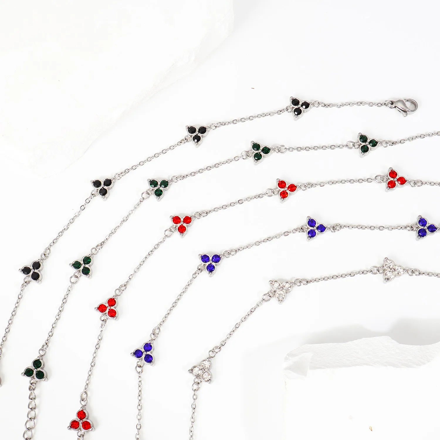 Women's stainless steel geometric bracelet with triangle elements and coloured stone settings