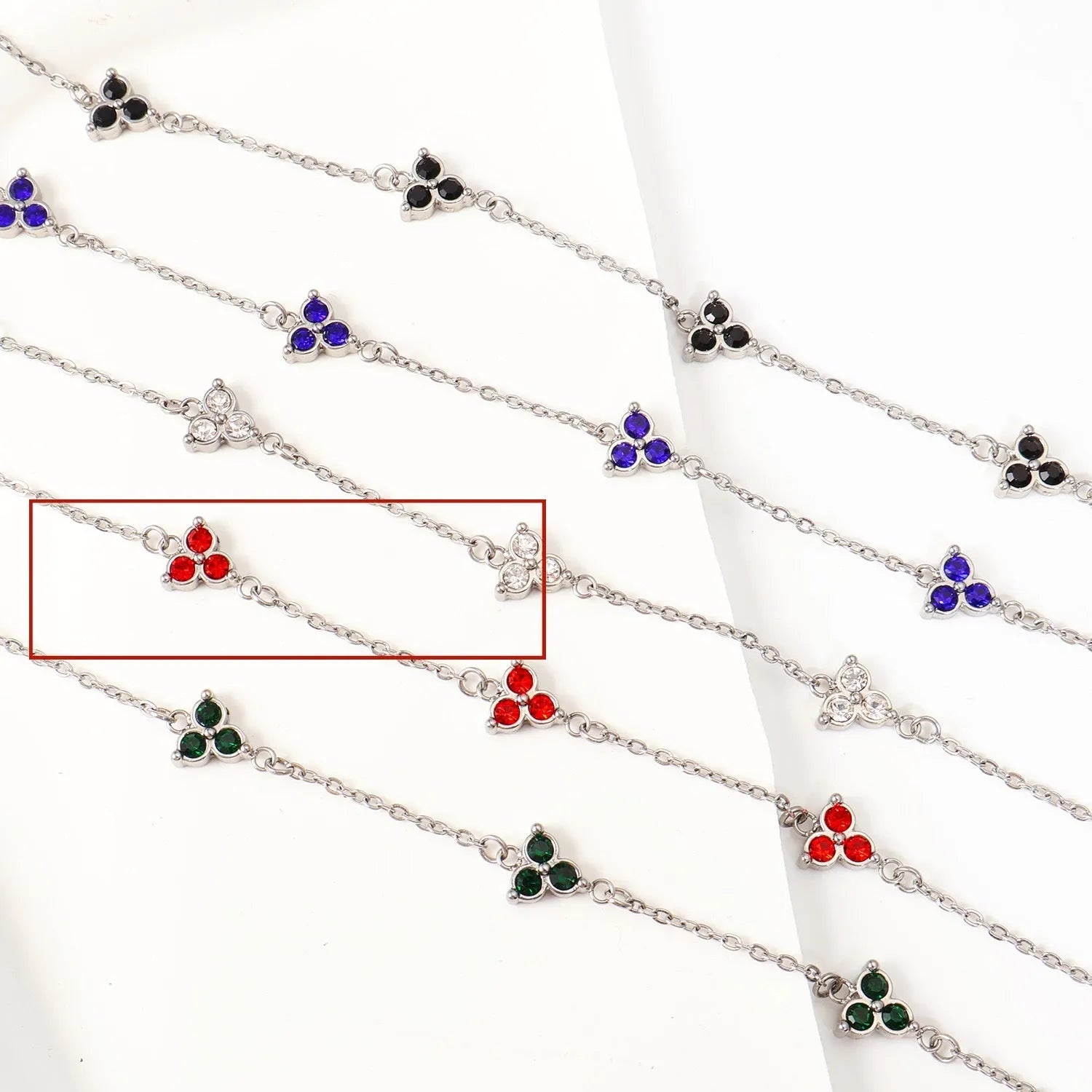 Women's stainless steel geometric bracelet with triangle elements and coloured stone settings