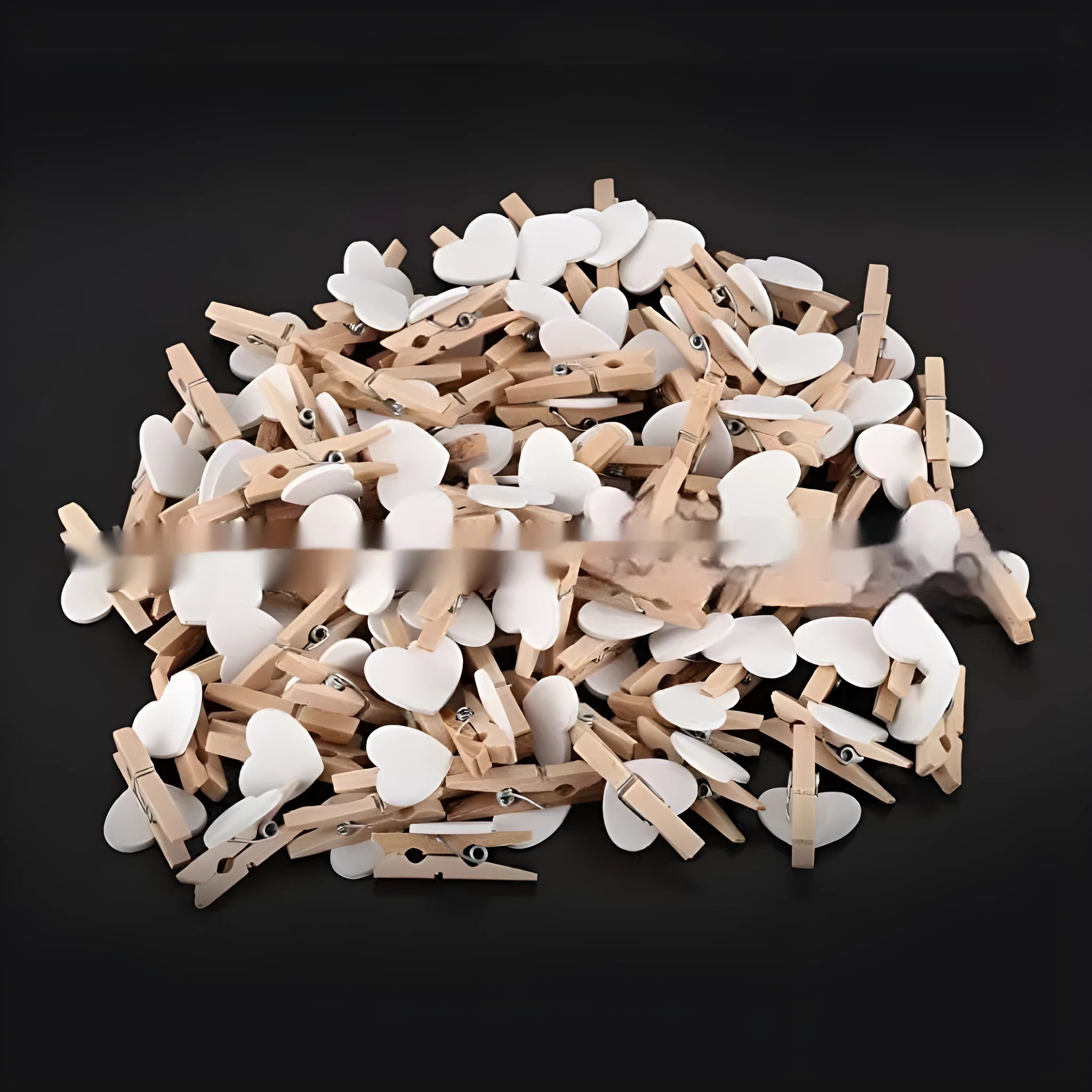 Five handmade solid wood heart-shaped clips in red, white, and pink on a wooden surface.