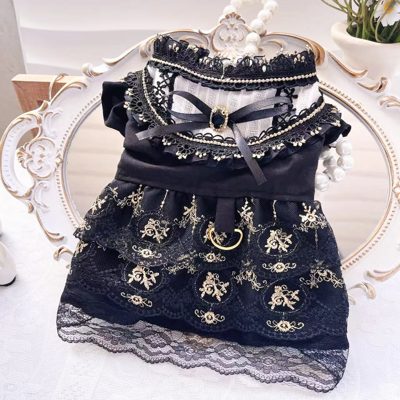 Golden Gothic princess skirt costume for a small dog on a mannequin, showing the tiered skirt design.