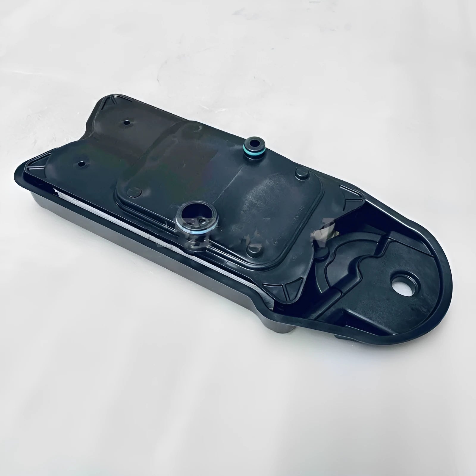 A black automotive crankcase ventilation filter for engine maintenance.