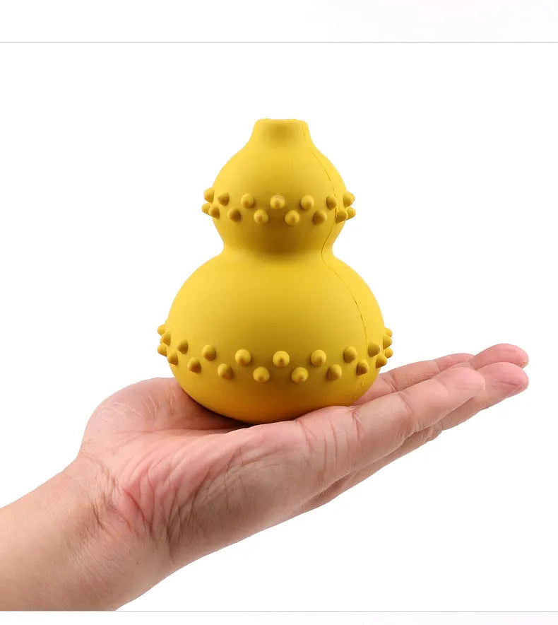Natural rubber pet toy resistant to biting and grinding, treat dispensing ball in red, 11.3 by 8.5 cm