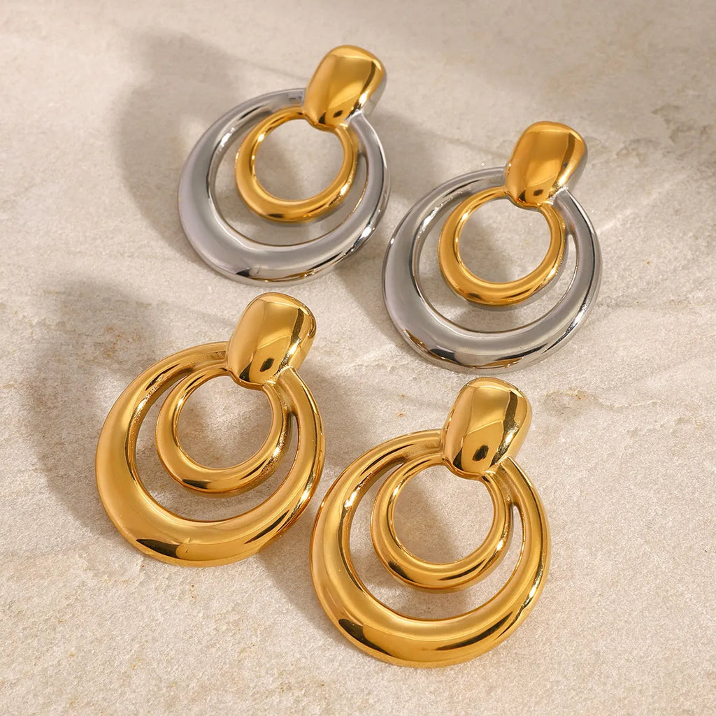Golden round stud earrings with double-layer hollow geometric design on titanium steel