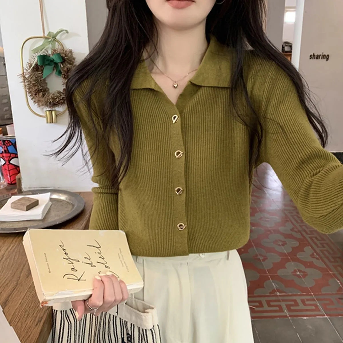 Long-sleeved loose knitted cardigan top in viscose fibre, shown in a neutral colour on a hanger.