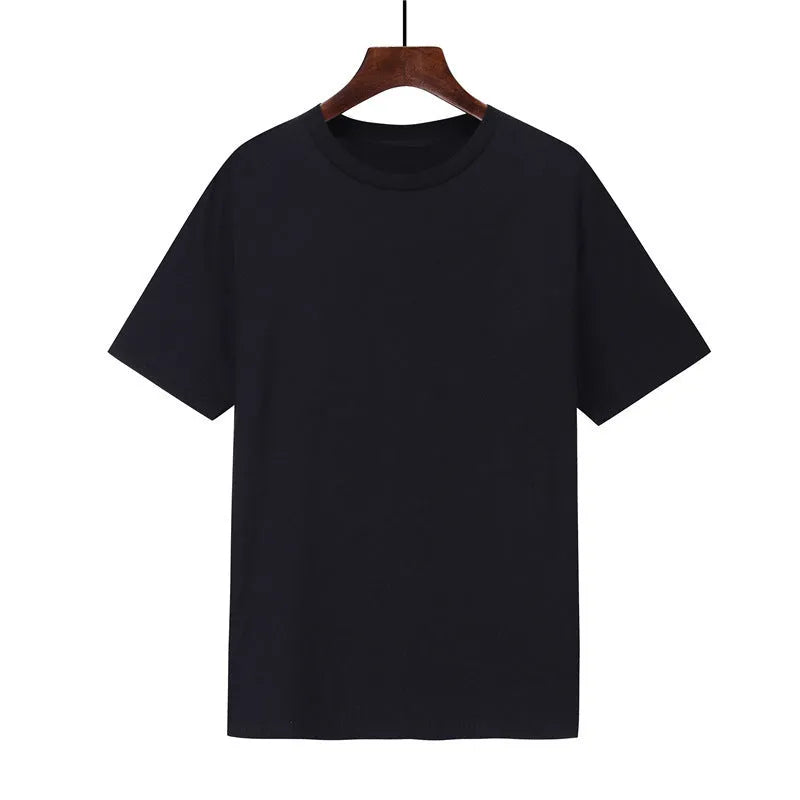 Man wearing a black loose-fit cotton T-shirt with short sleeves, showcasing casual style.