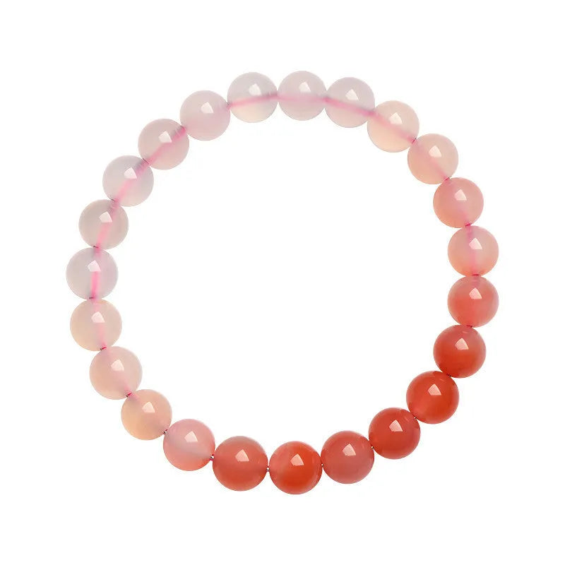 Natural gradient Yanyuan agate bracelet with spherical beads on a white background.