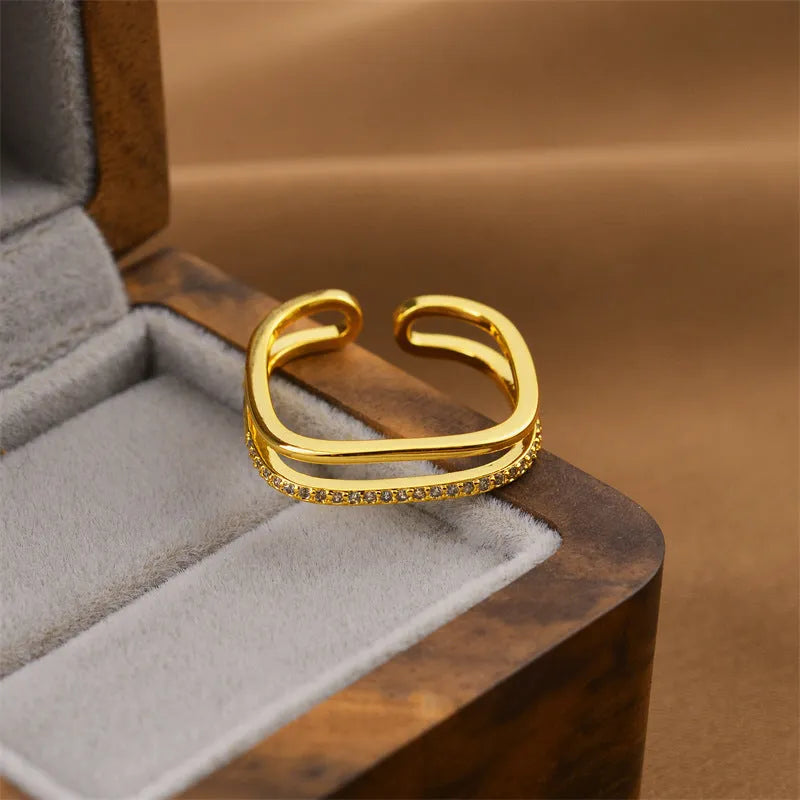 Gold geometric open fashion ring made from electroplated copper, shown in a Korean-inspired style.