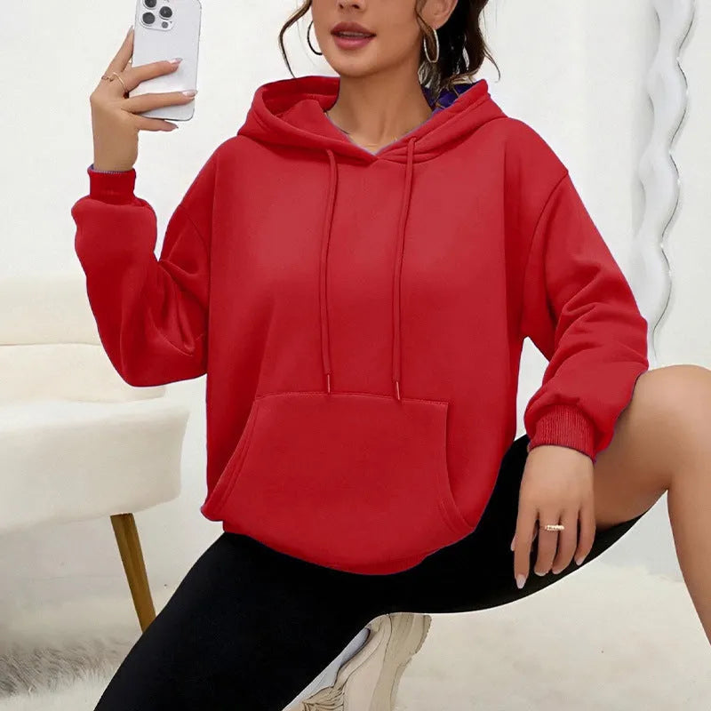 Women's loose grey drawstring pocket sweatshirt with long sleeves on a hanger.