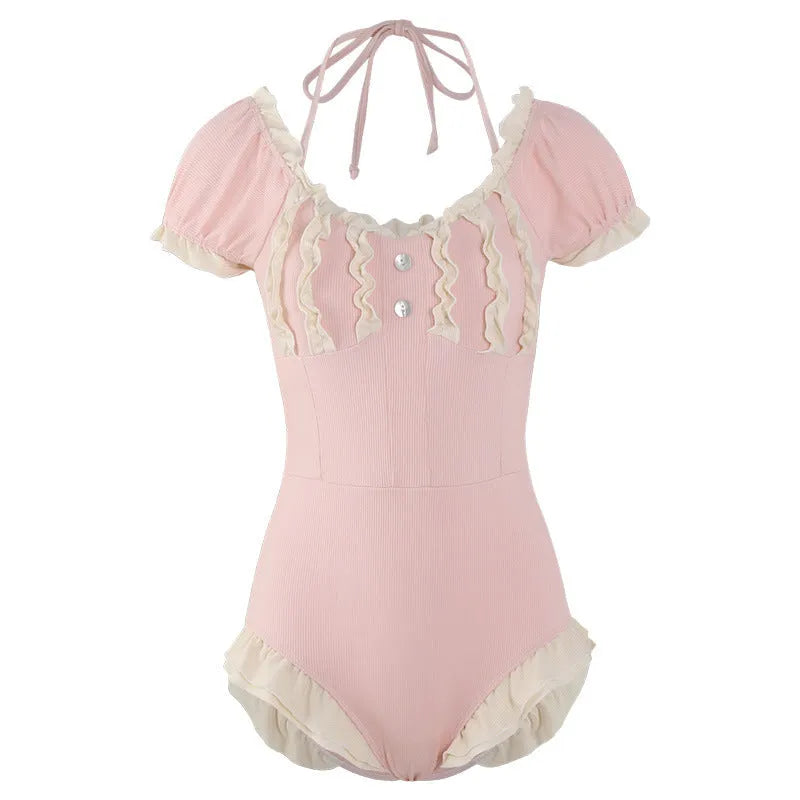 Pink women's conservative one-piece swimsuit with Siamese styling on mannequin
