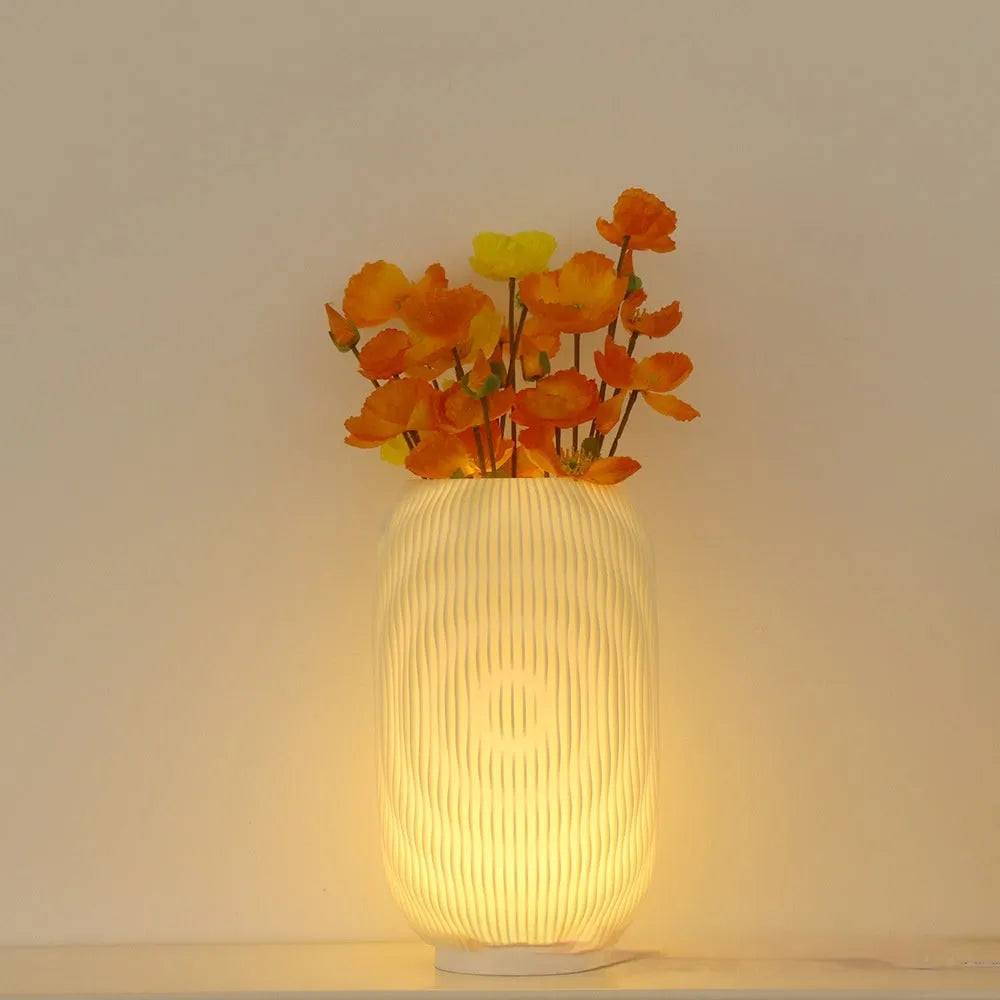 3D printed cylindrical vase night lamp in wood colour finish on a modern bedside table