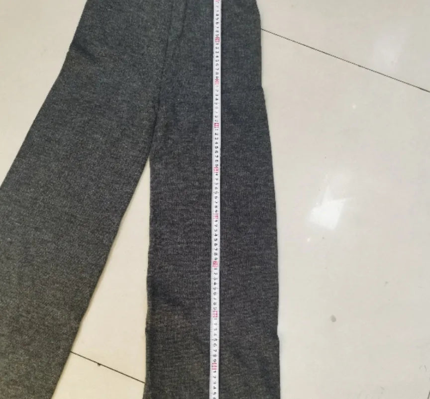 Women's dark grey acrylic sweater with side slits paired with matching trousers