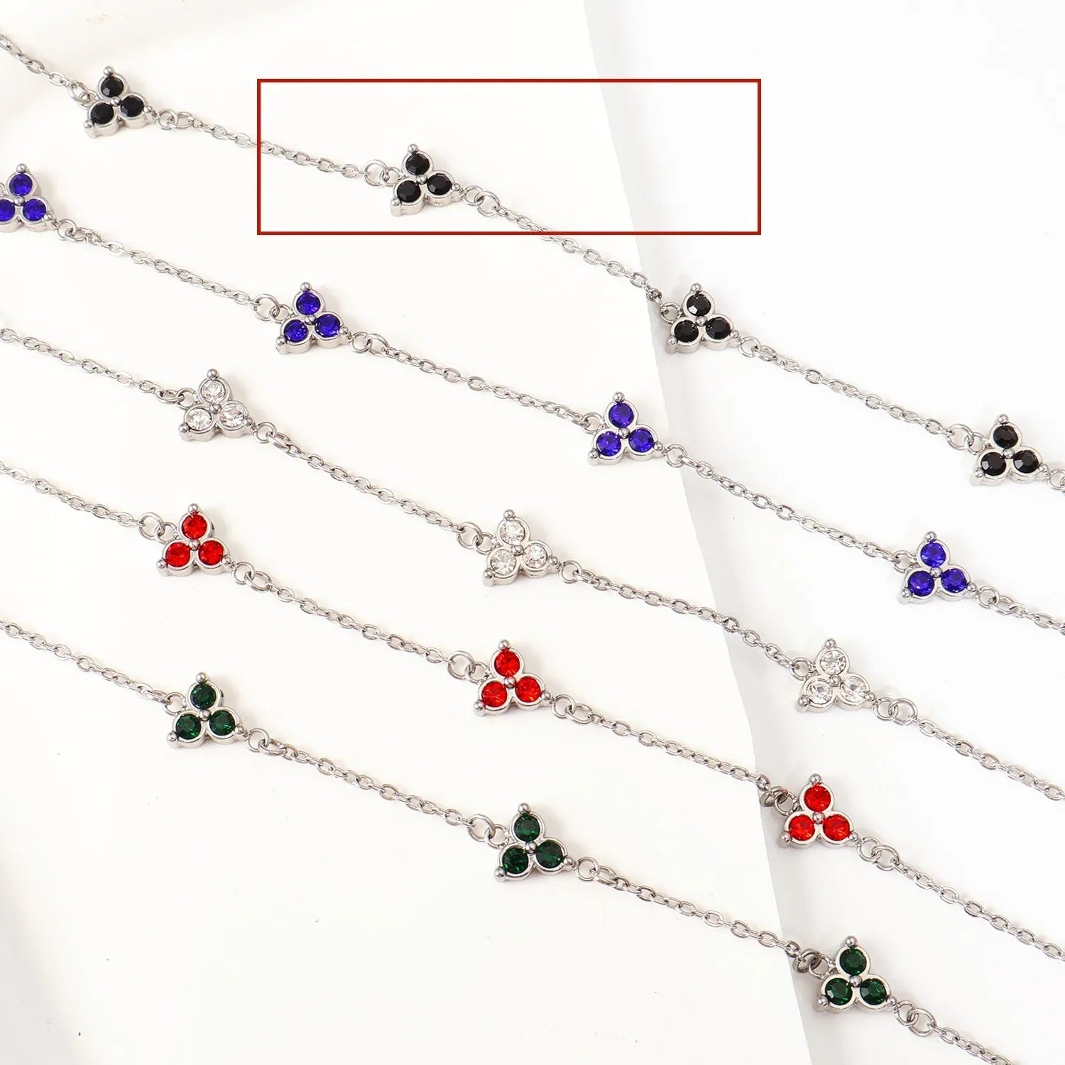 Women's stainless steel geometric bracelet with triangle elements and coloured stone settings
