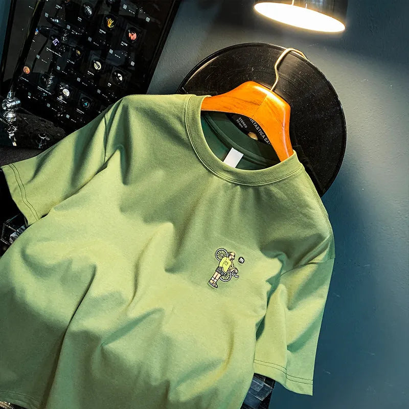 Green men's t-shirt with printed literary youth design showing loose fit and short sleeves