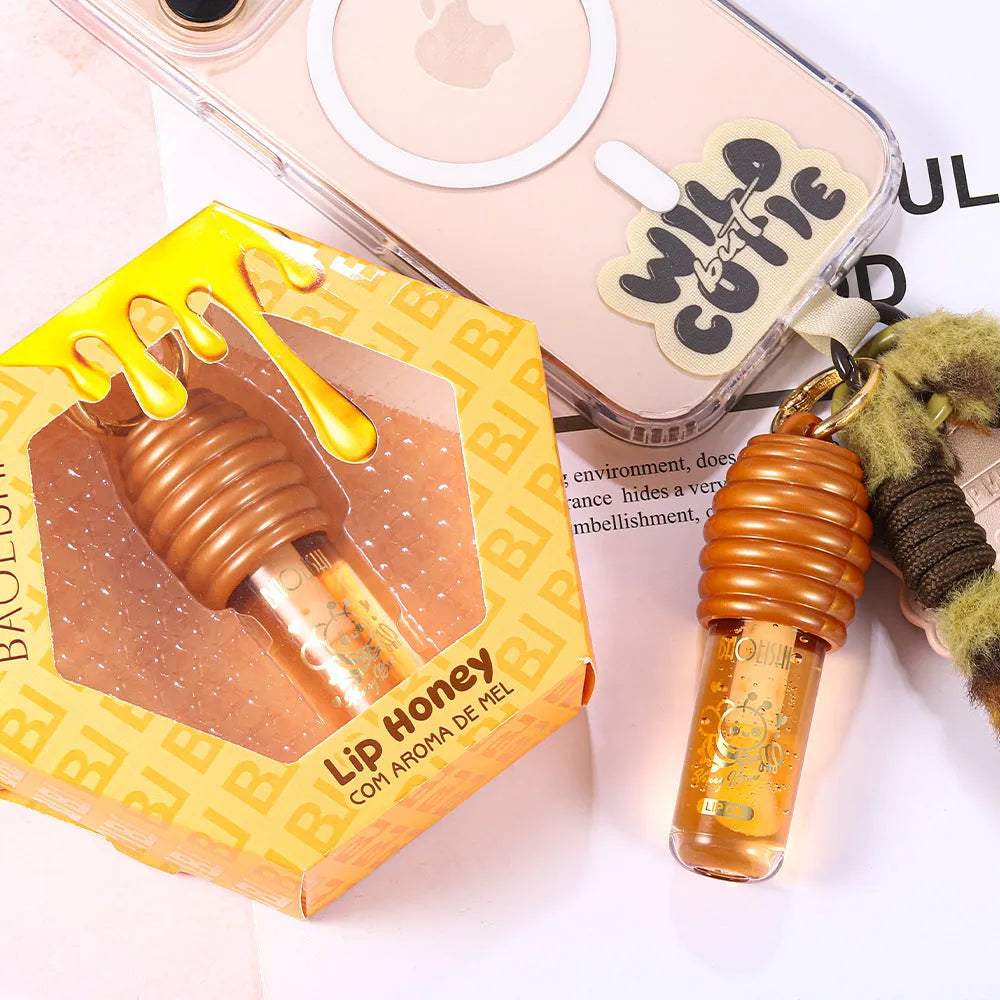 Honey lip gloss attached to keychain showing portable design