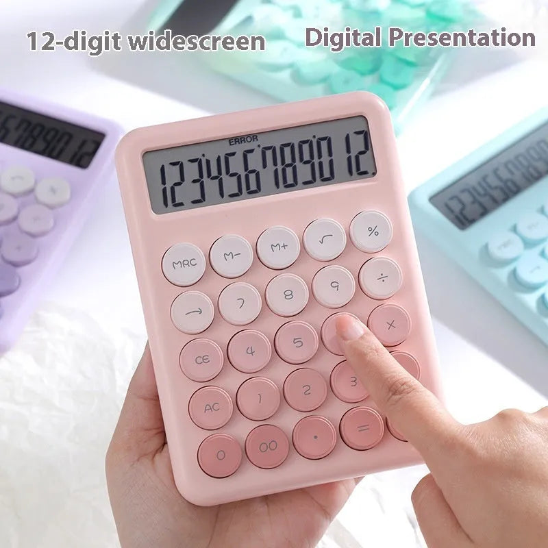 Desktop calculator with a gradient colour design in violet, blue, green, and pink tones on a white desk.