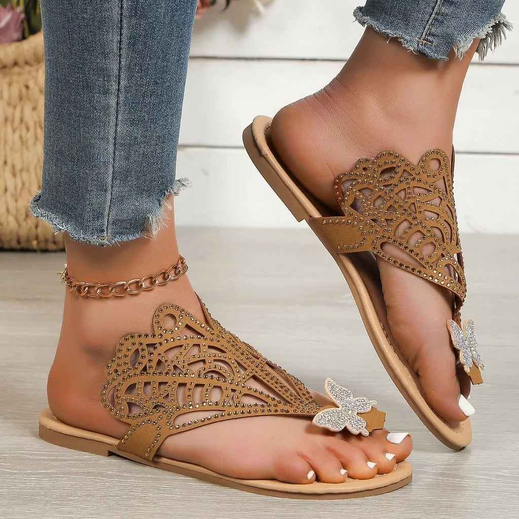Women's black flip-toe sandals with rhinestone detailing and hollow design on flat rubber sole