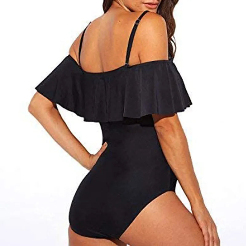 Black one-piece swimsuit with cut-out detail and ruffled straps on a mannequin.