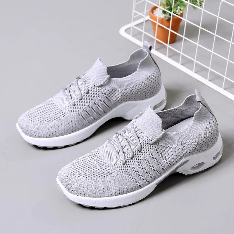 Women's black mesh sneaker with lace-up front and round toe on a non-slip PVC sole.
