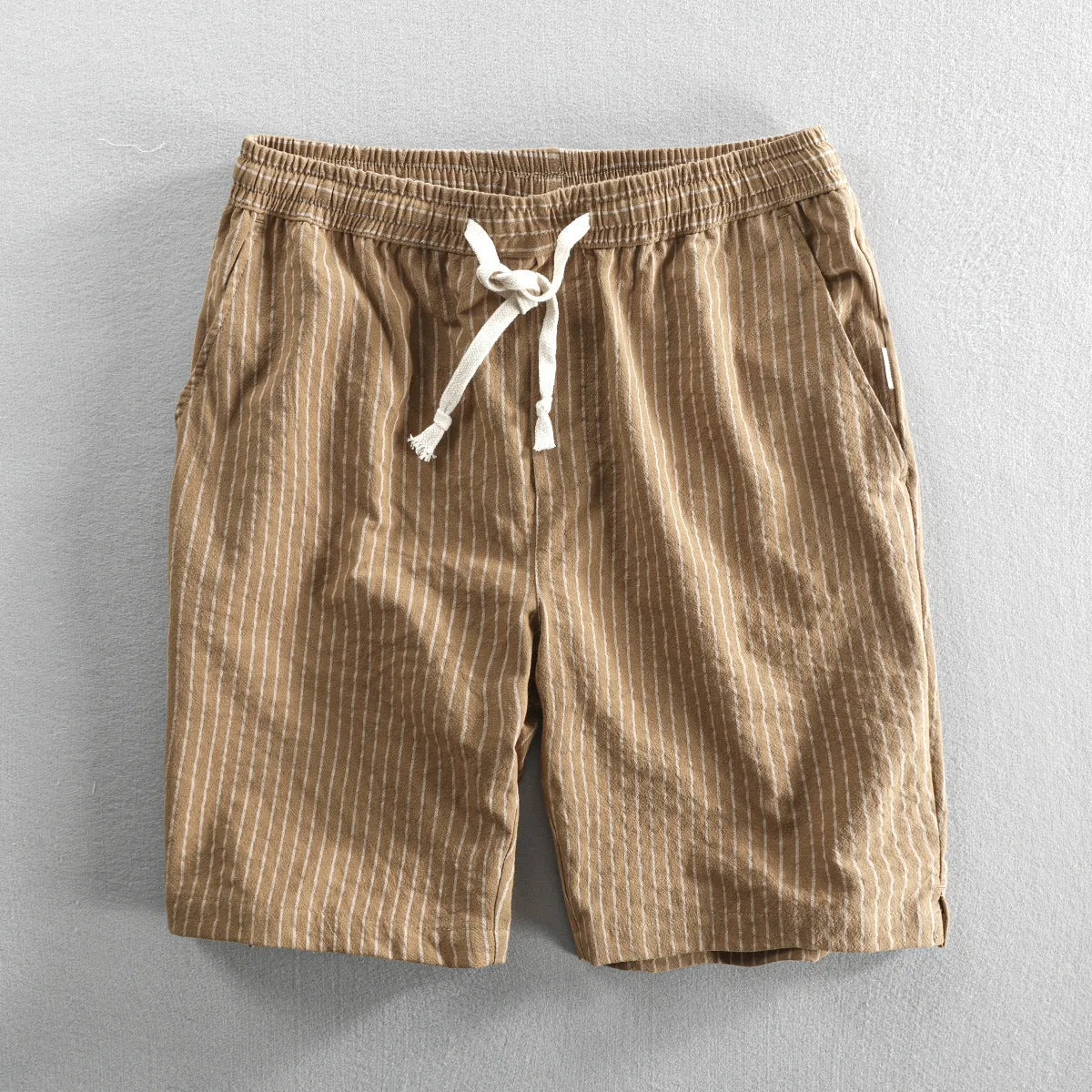 Men's striped cotton casual shorts in a loose straight fit on a mid-waist, shown in light blue colour.
