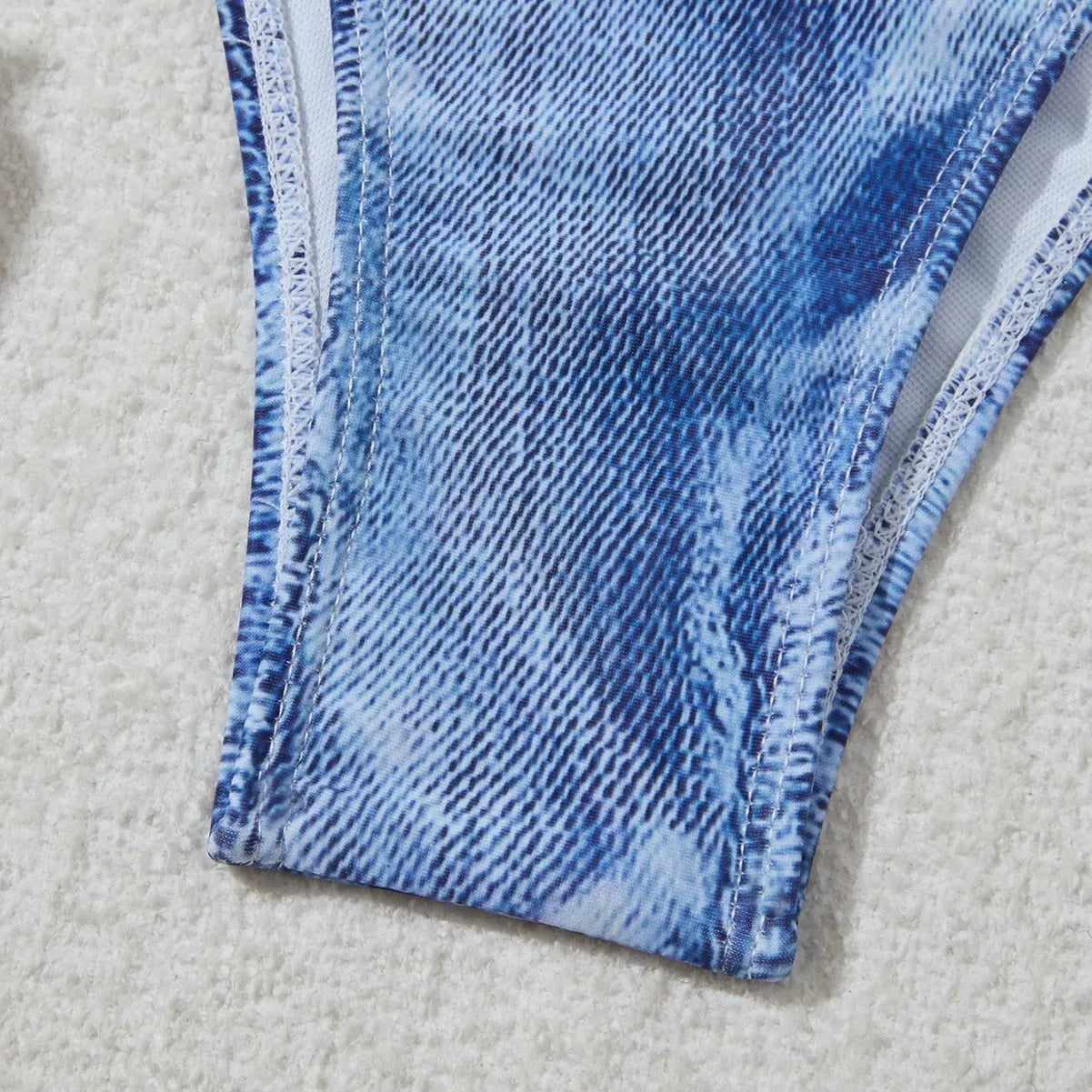 Denim blue printed women's bikini set with strap design on a model, showing front and back.