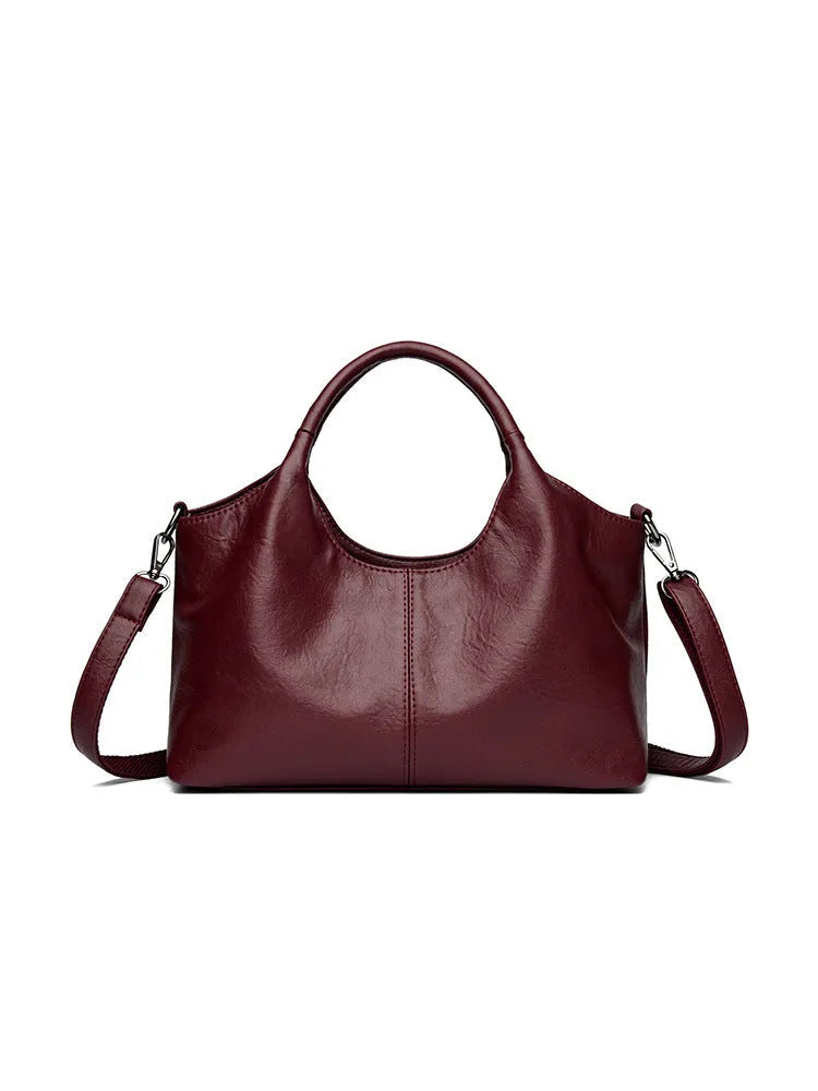 Women's genuine leather crossbody bag in beige colour showing soft construction and large capacity