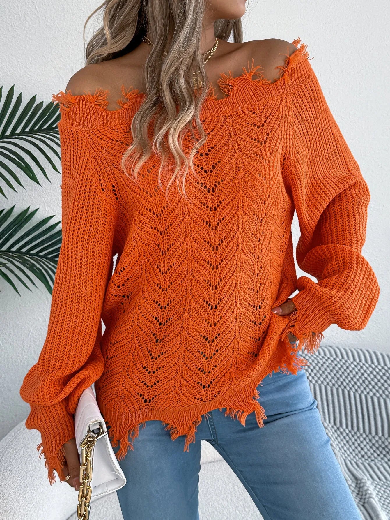 Women's white hollow-out pullover sweater with cut off-the-shoulder design and long sleeves