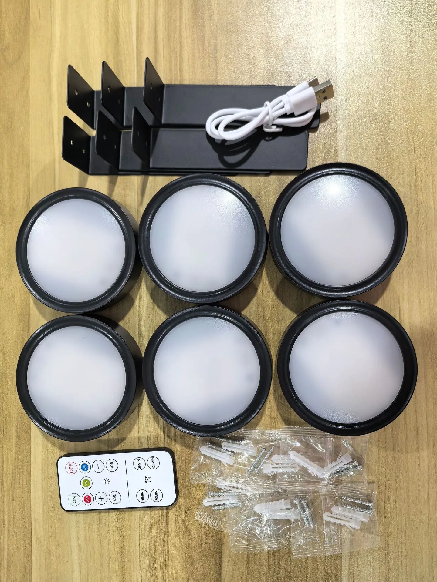 Wireless rechargeable LED painting lamp with magnetic belt attached to a metal frame, remote control nearby.