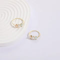 Geometric triangle ring with tricolour zircon stones in horse eye pattern and gold colour finish
