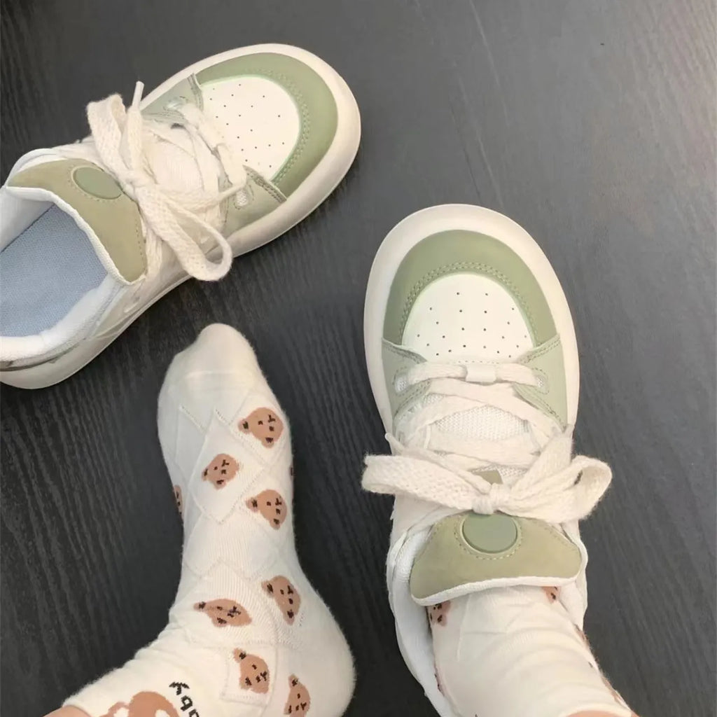 Green women's casual lace-up shoes with PU mesh upper and flat heel on a white background.