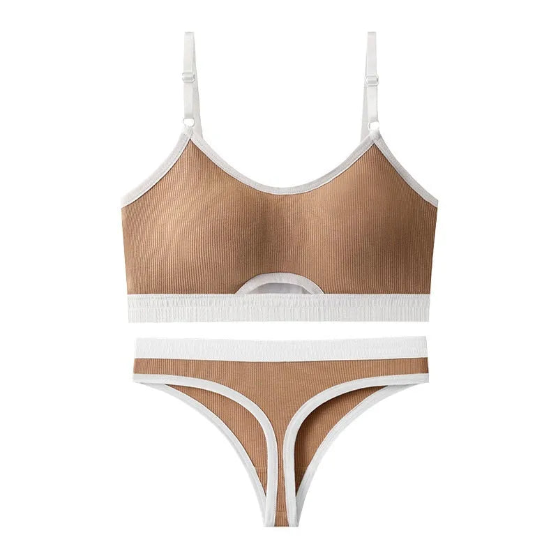 Women's contrast back sports bra vest and briefs set in black with underwire and padding.